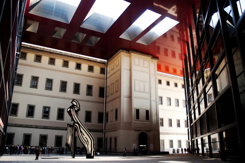 Entrance of the Reina Sofía Museum in Madrid with a surrealist statue in the center of the exterior courtyard