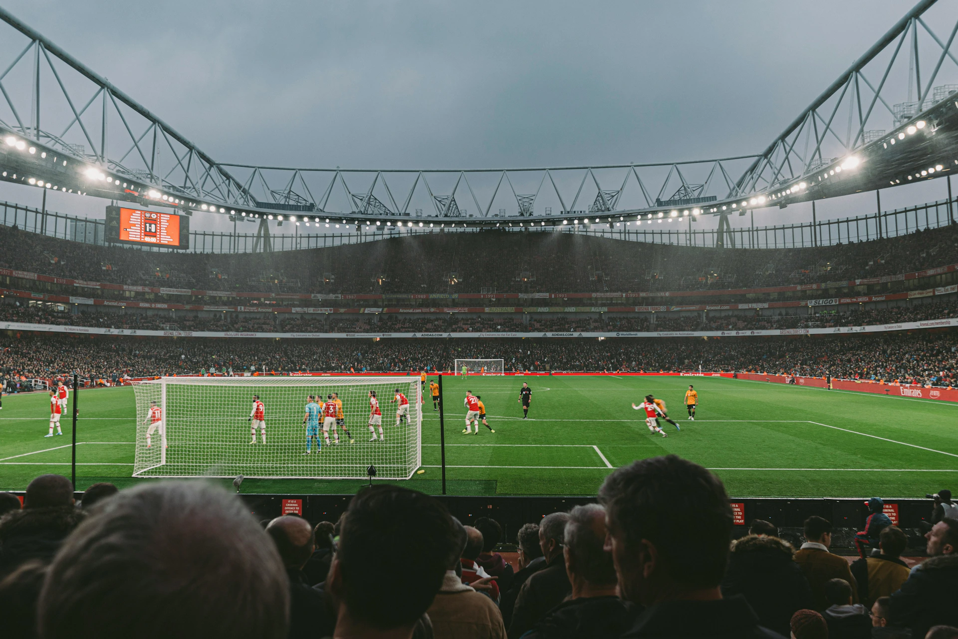 Audience watching Arsenal play from behind the goal