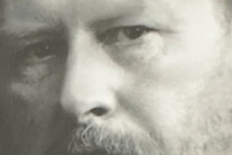 A person looks at a display featuring a portrait and information about Bram Stoker, with his name prominent at the top.