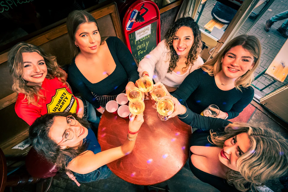 Image of guests cheering at one of the bar