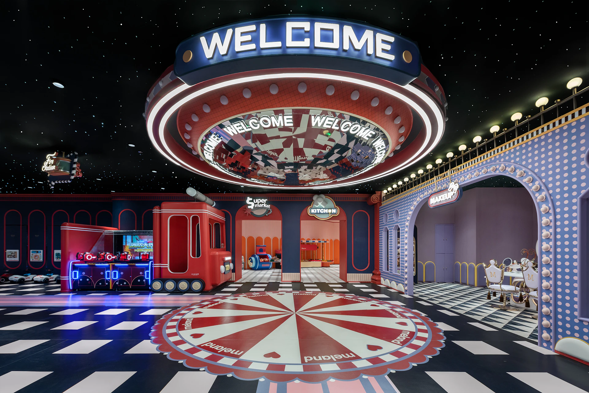 A colorful indoor space with a large 'Welcome' sign, checkerboard flooring, and themed decorations resembling a carnival.