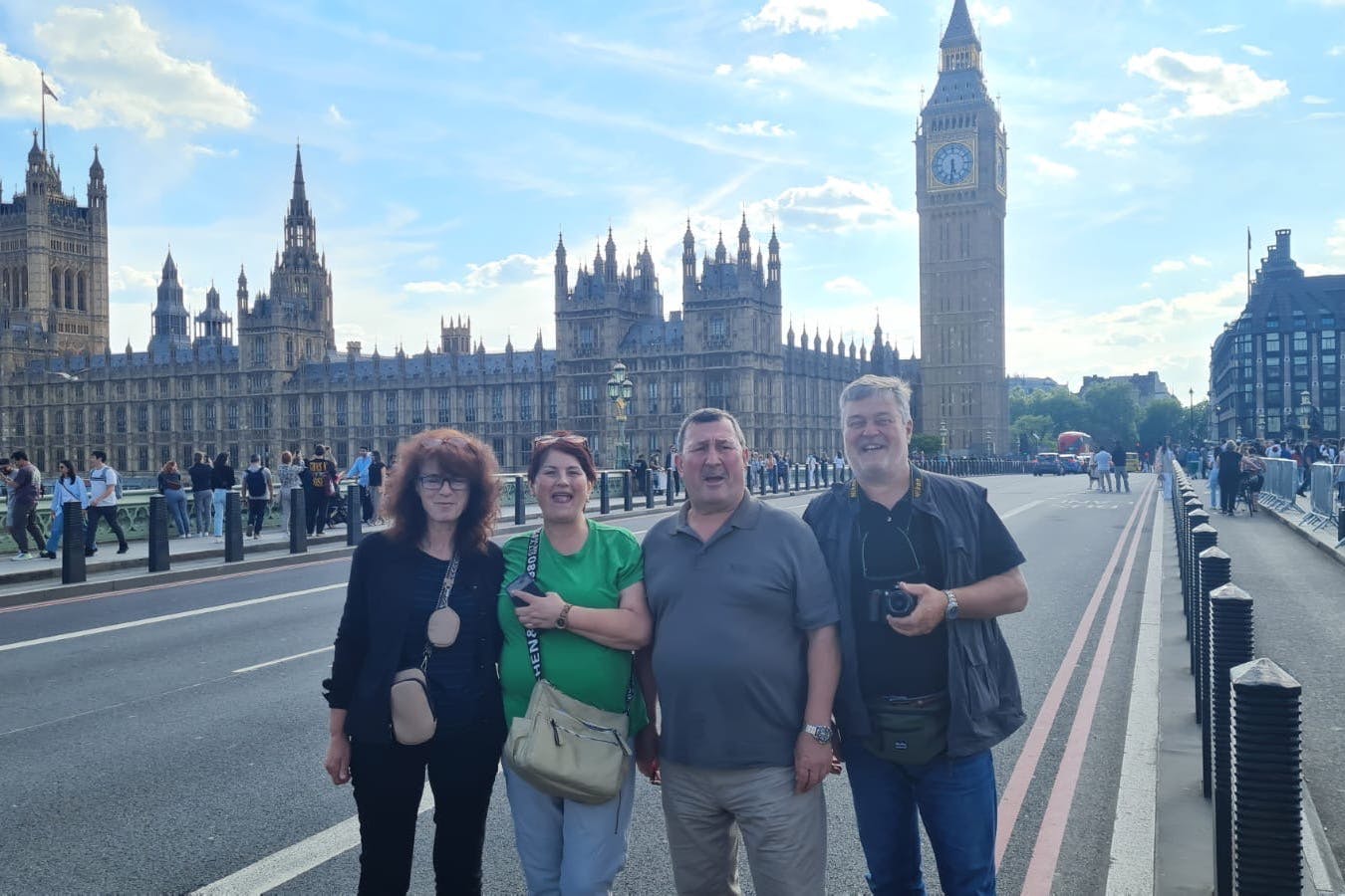 Family standing on bridge near Big Ben