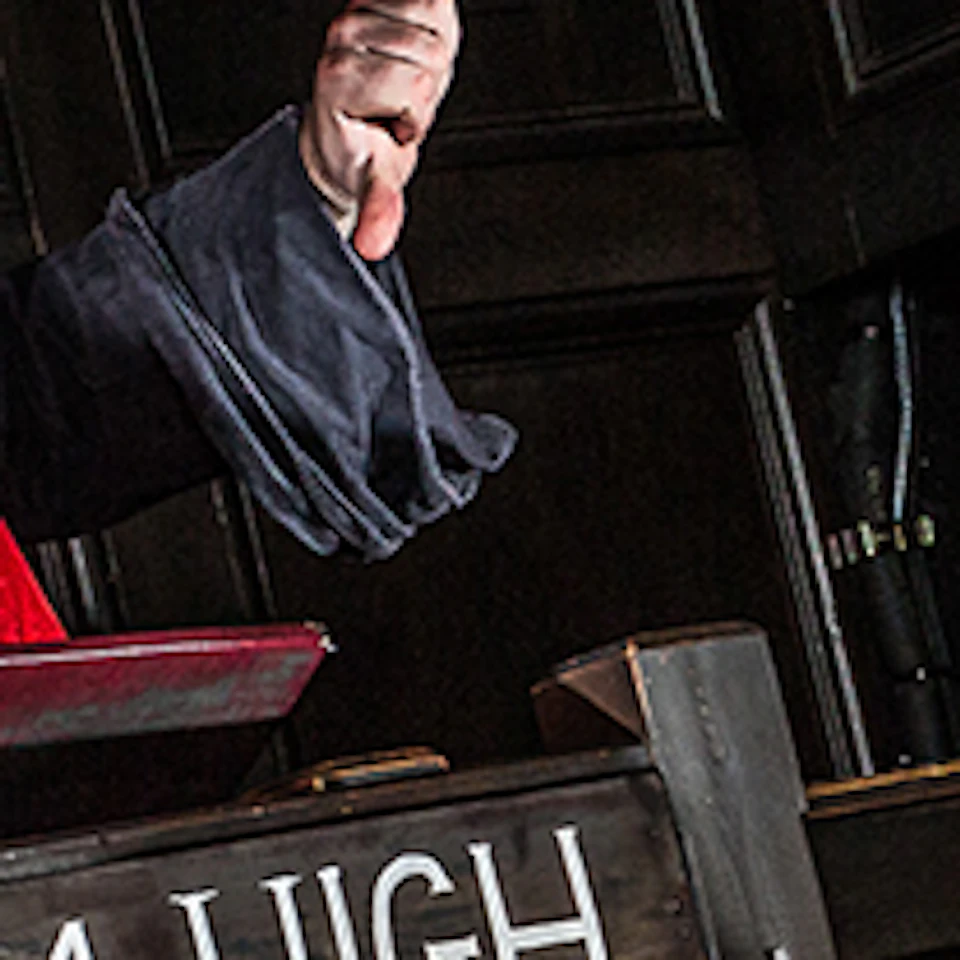 A judge in a white wig and red robe presides over a man in a witness stand, surrounded by people pointing. Sign reads "Hang 'Em High."