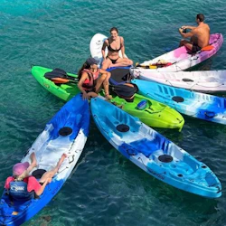 Group of people in kayaks standing in the open sea