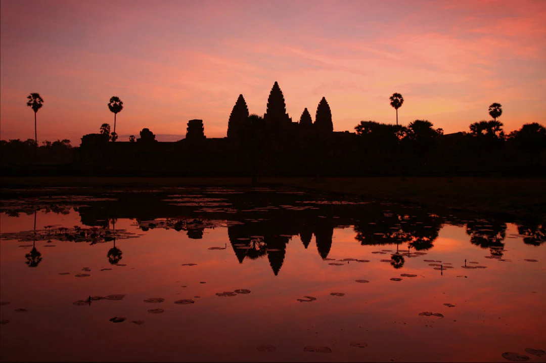 Witness the glow of the sun rise over the historic Angkor Wat complex on this memorable Vespa tour.

