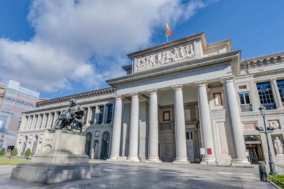 Facade of Prado Museum in Madrid with Velazquez statue