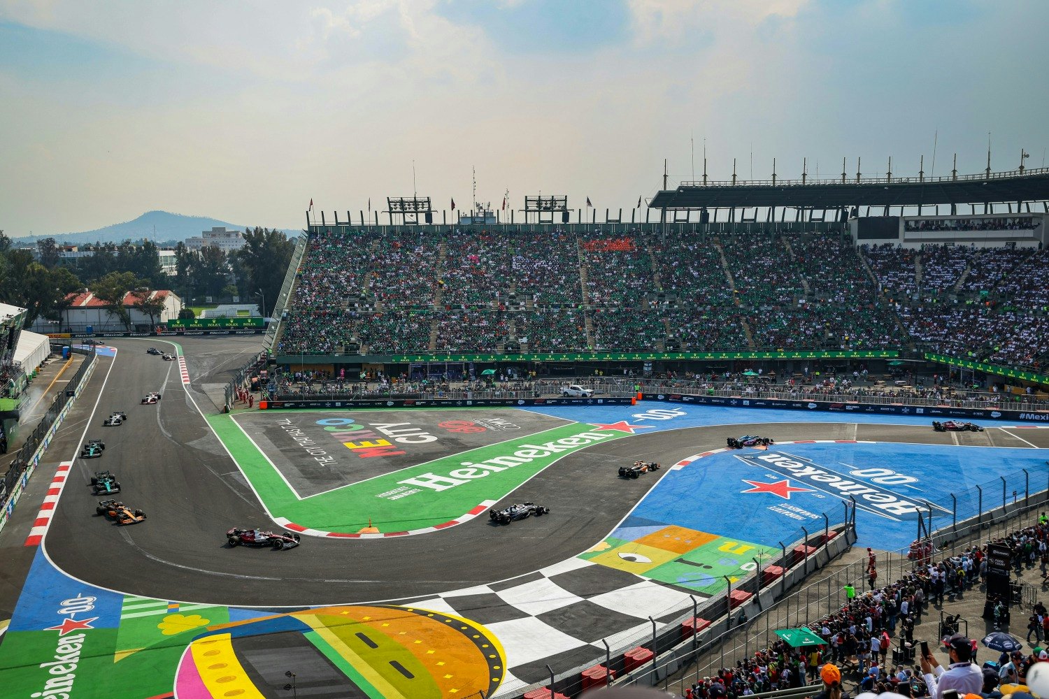Formula 1 cars racing through the Autodromo Hermanos Rodriguez in Mexico City