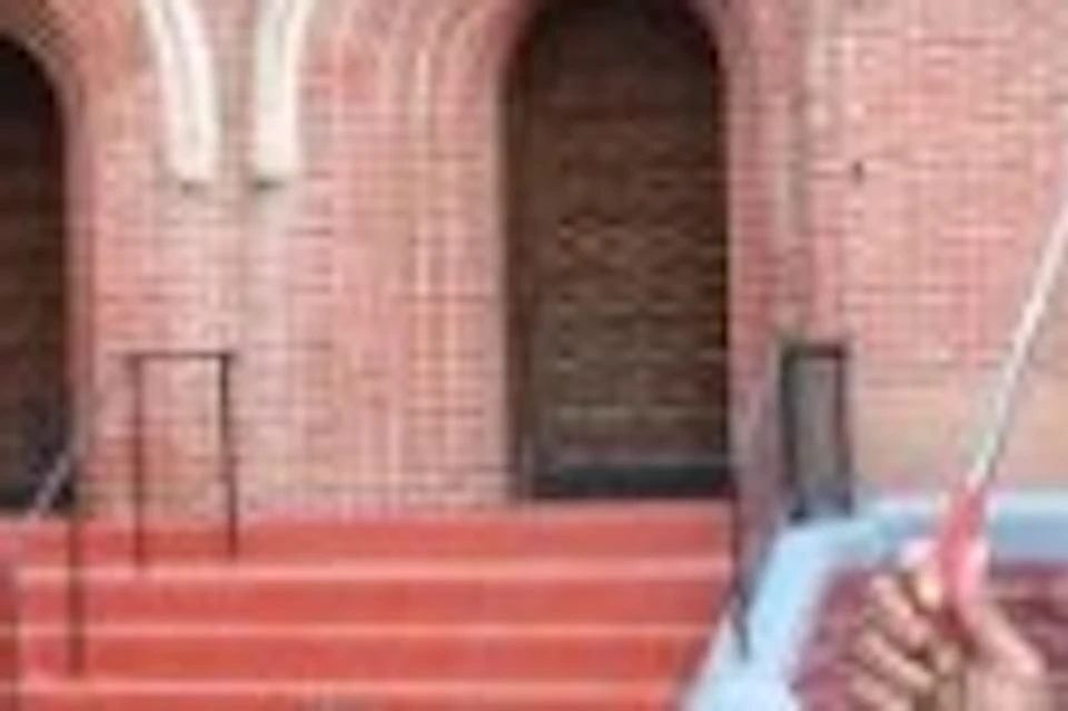 A vibrant photo of our tour guide standing proudly in front of Harlem's iconic church.