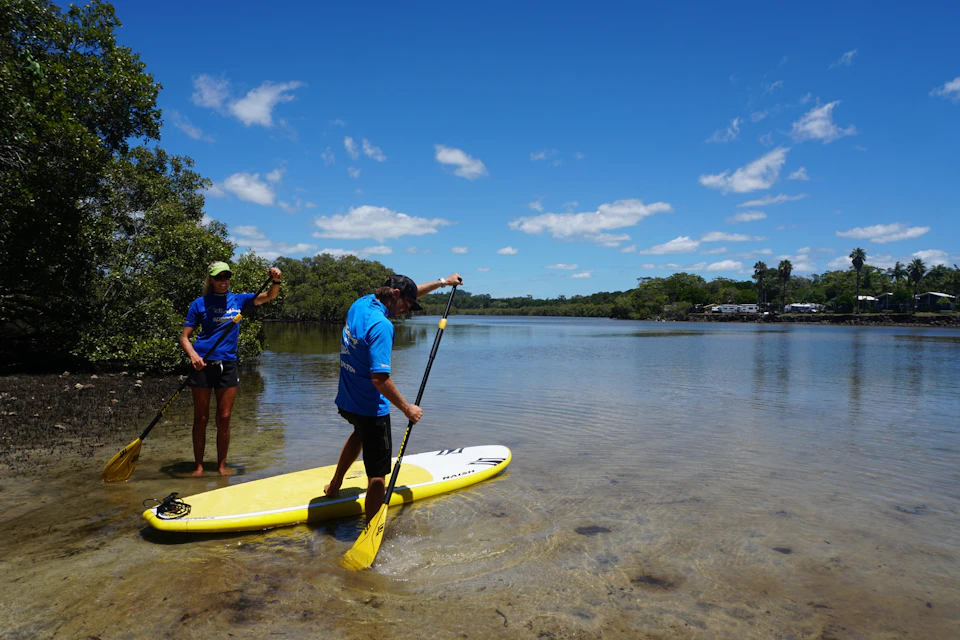 Entering the river on the stand-up paddleboard.