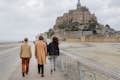 Group of friends going together to the abbey of Mont Saint-Michel