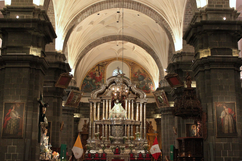 Ornate church interior with a grand altar, detailed arches, and religious flags. The scene includes intricate carvings and paintings.