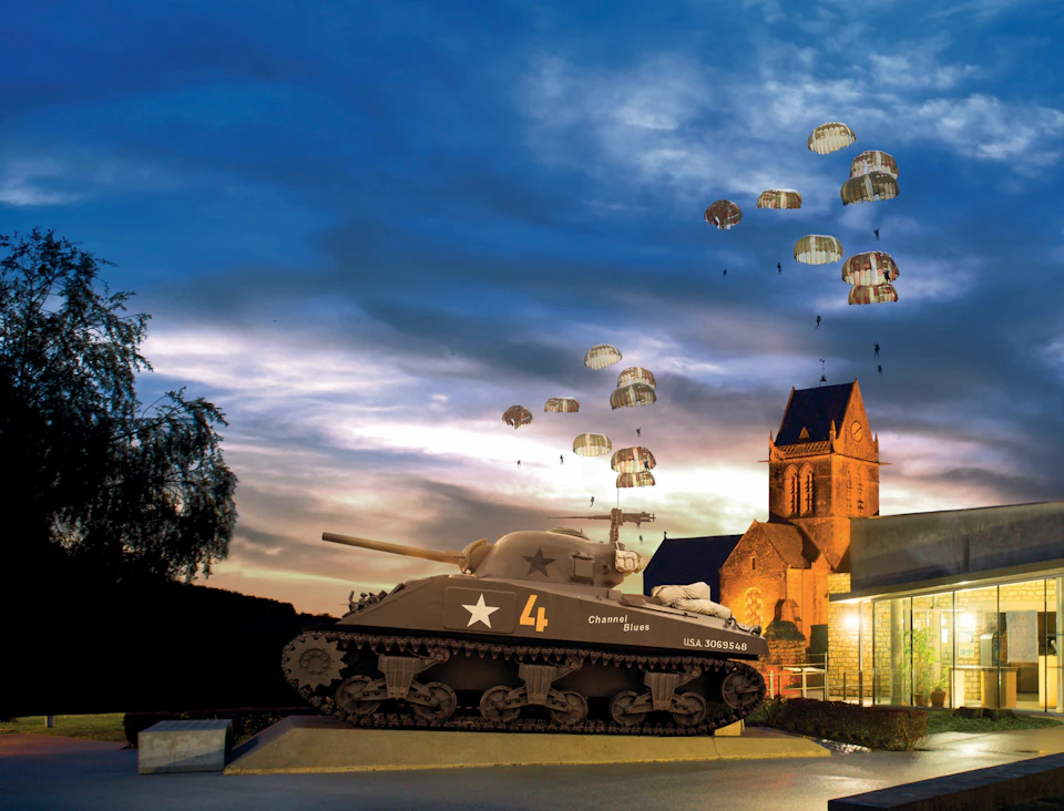 A tank bearing the number 4 is on display outside, with several parachutes descending from the sky. A church can be seen in the background.