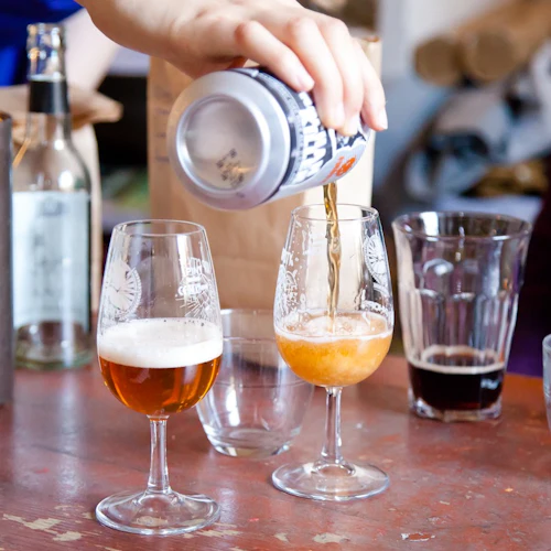 Pouring different styles of Scottish beer into tasting glasses