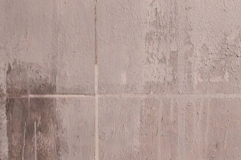 A couple conversing in front of a Banksy artwork.