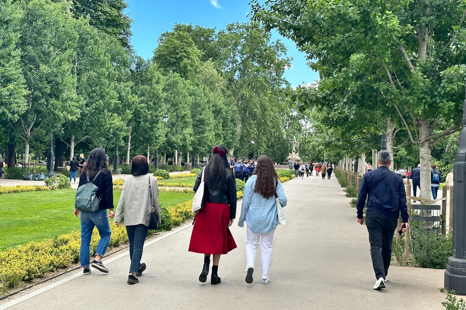 Visitors strolling through El Retiro park