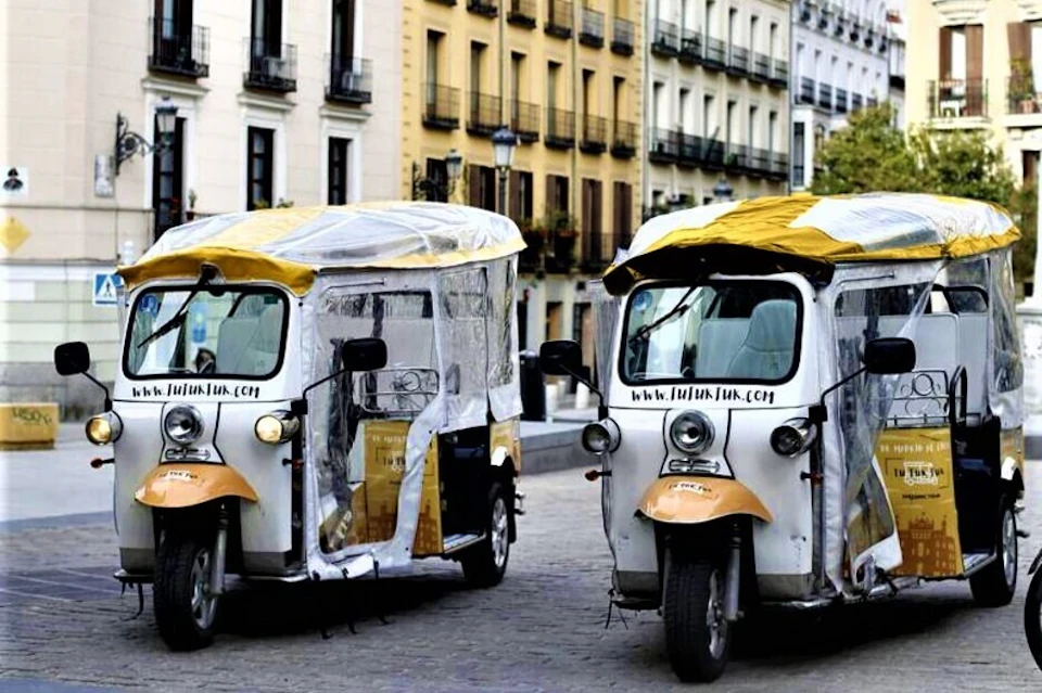 2 yellow tuk tuks