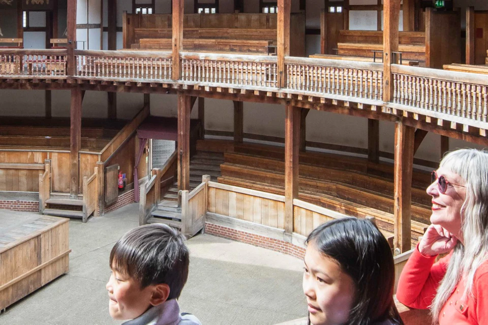 A tour group booking out at the Globe Stage in the Middle Gallery of the Globe Theatre.