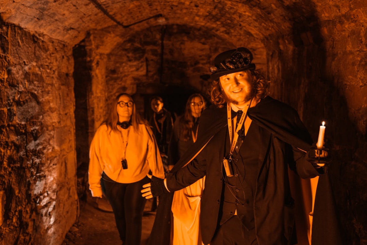Storyteller leading visitors through the Blair Street Underground Vaults