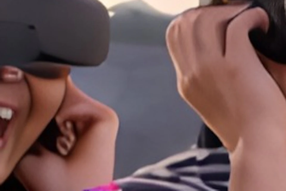Two people wearing VR headsets react excitedly in a simulated historical battle scene with soldiers and a cannon.