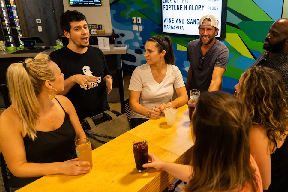 Tour guide talking to guests while having drinks