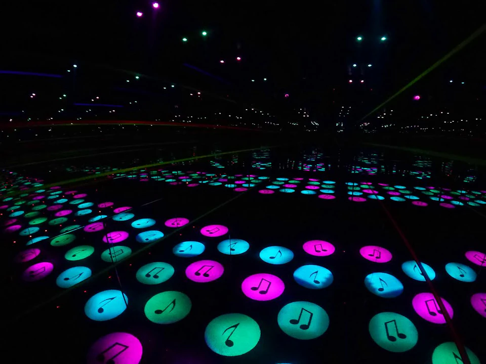 Glowing musical note icons in blue, pink, and green are reflected in mirrors, creating an illusion of endless patterns.