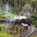 Puffing Billy Steam Train traveling over a trestle bridge