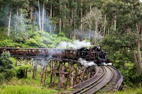 Puffing Billy Steam Train traveling over a trestle bridge