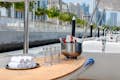drinks, glasses, hand towels placed on table at upper deck of yacht