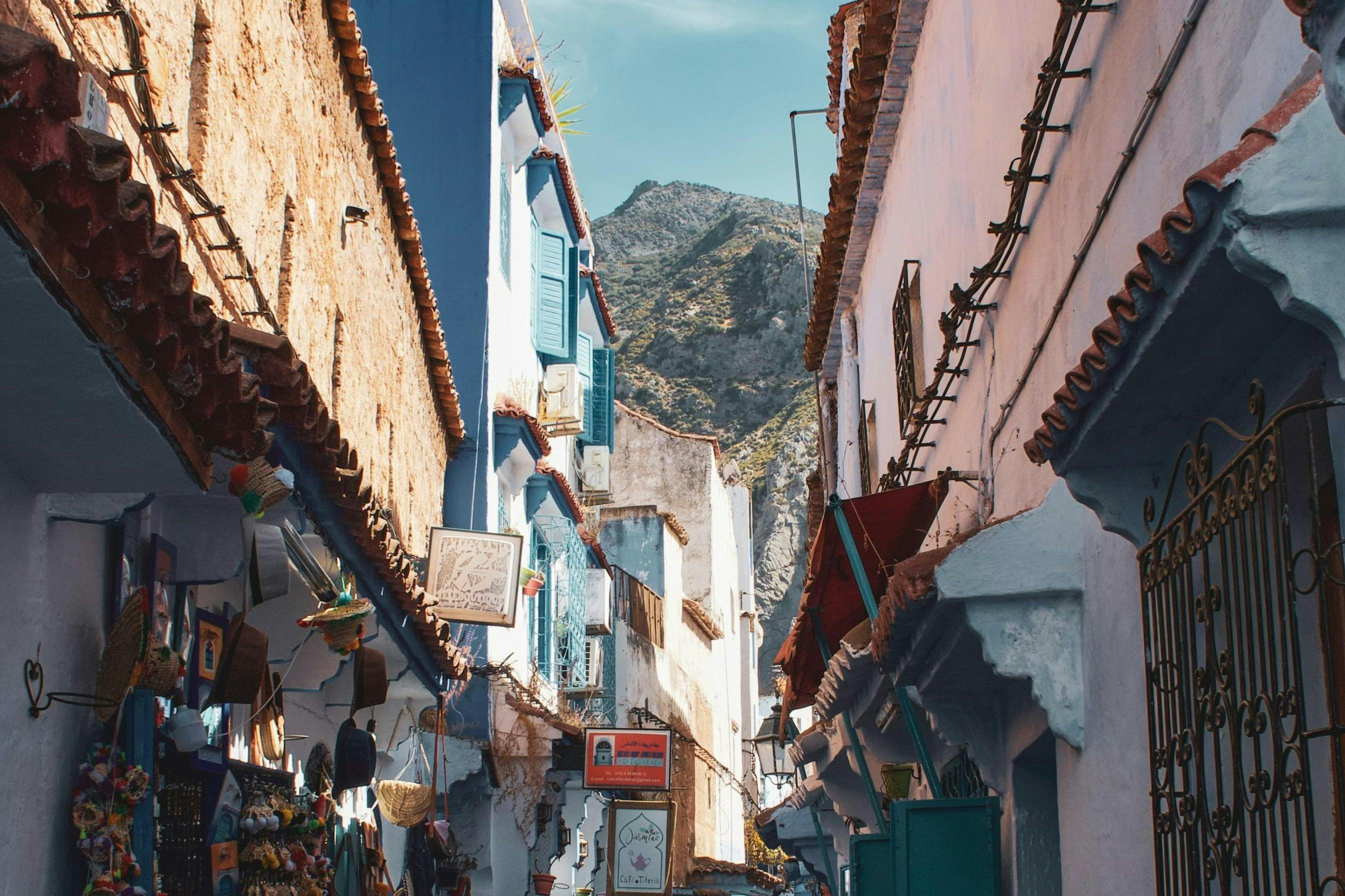 Narrow street with blue facades and artisan shops in the medina of Tetouan, Morocco