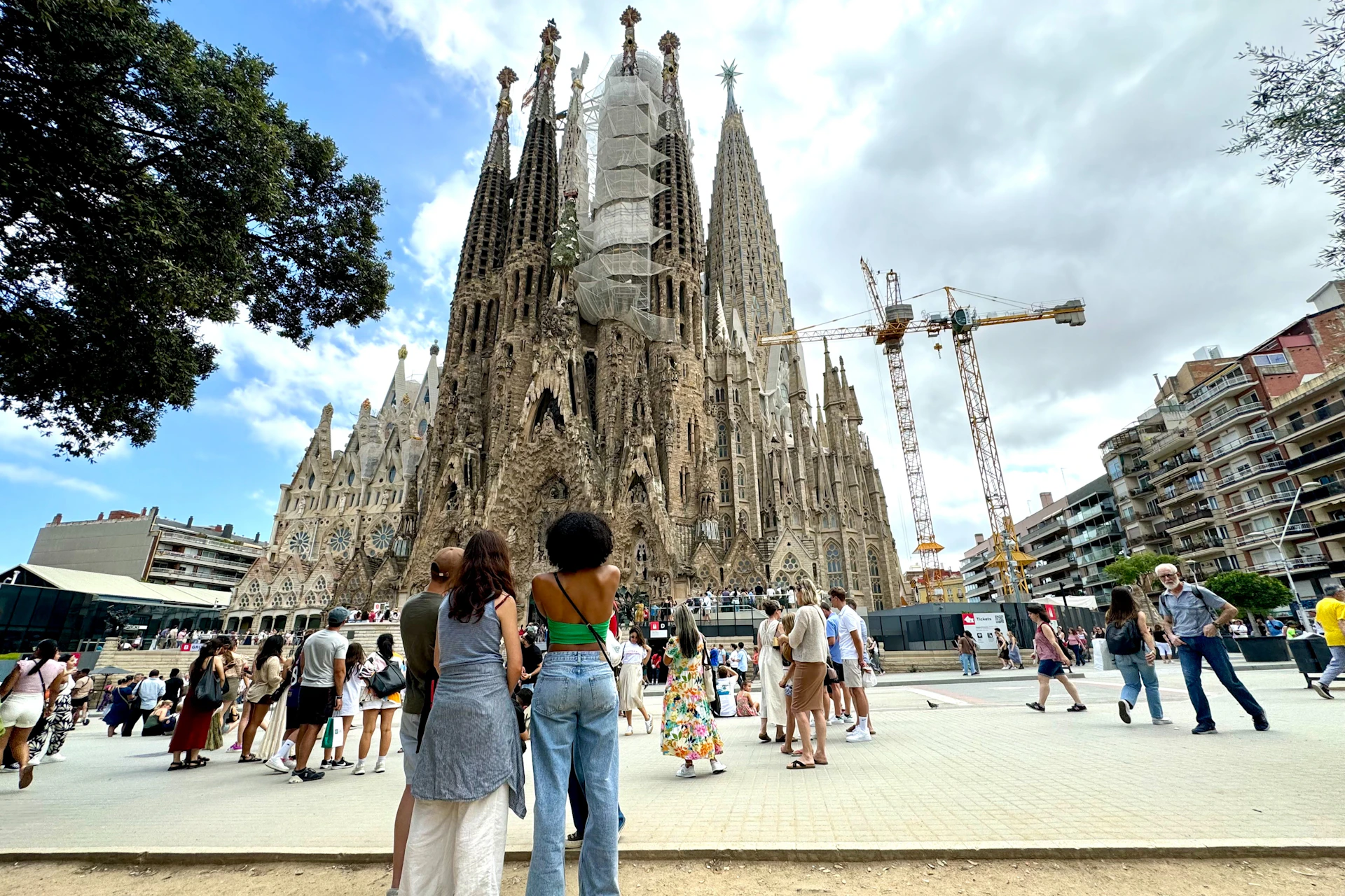 Group of travelers observing the intricate details of the Sagrada Familia in Barcelona.