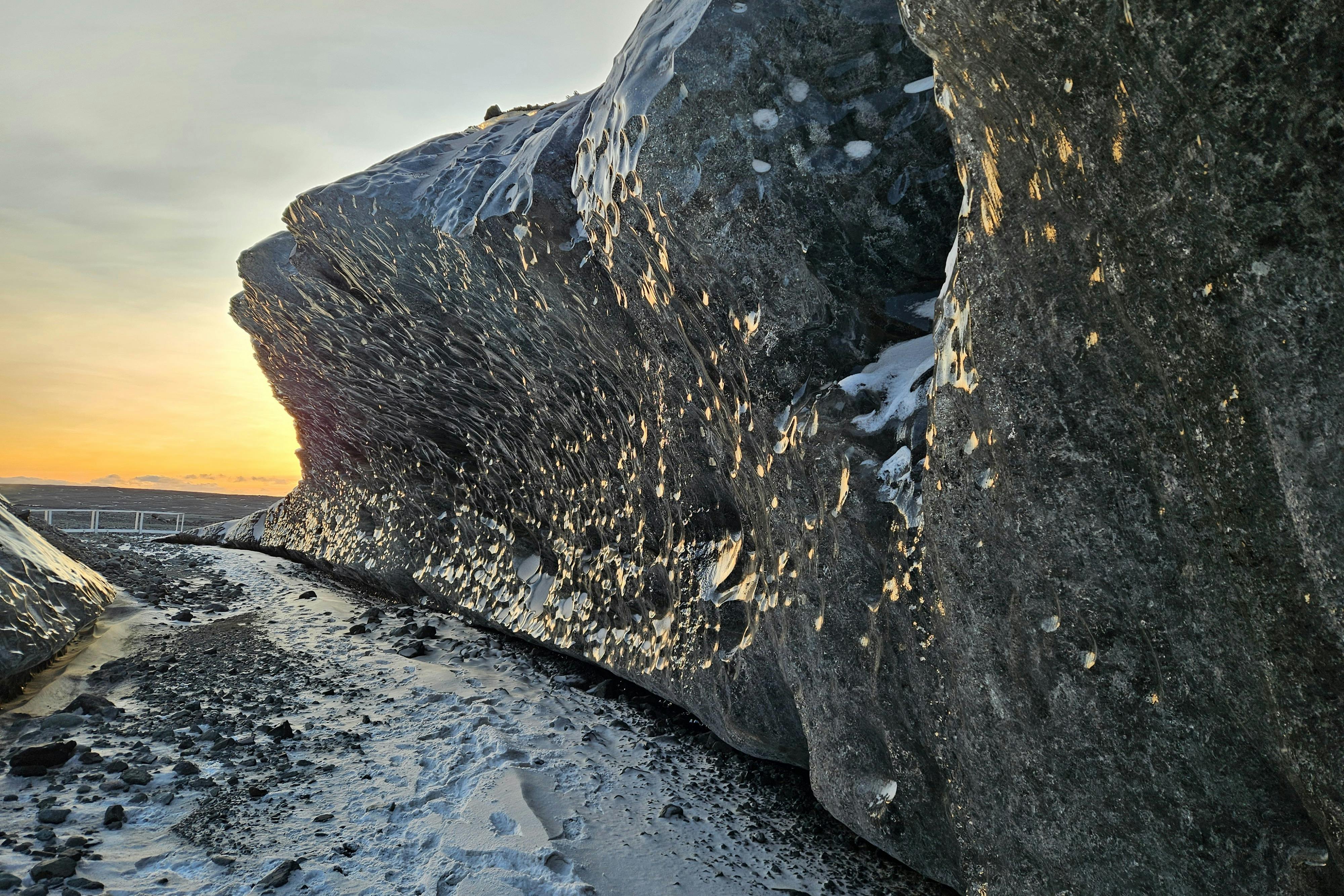 The smooth walls of the ice cave reflect the sunlight.
