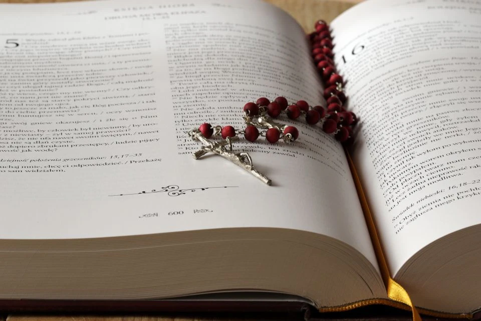 Rosary laid between the pages of the holy bible