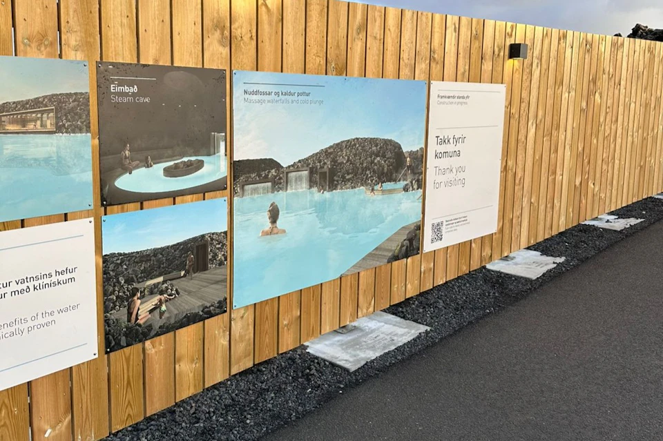 Wooden fence with three spa-related images and signage featuring English and Icelandic text thanking visitors.
