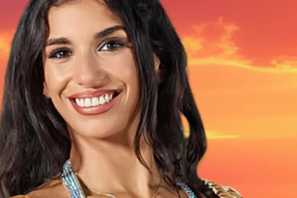 Three women in belly dance costumes perform with flowing fabric, set against a vibrant sunset background.