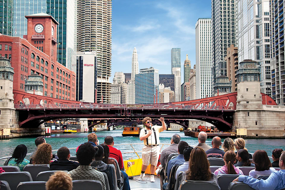 guide and tourists aboard a vessel on an architectural river and lake tour in chicago