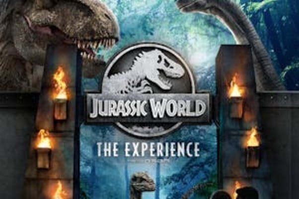 "Jurassic World: The Experience" poster featuring a T-rex, a Brachiosaurus, and flaming torches against a jungle backdrop.