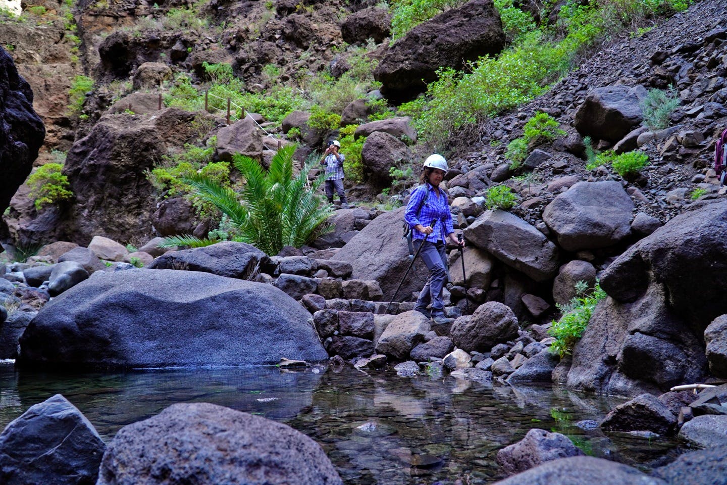 一对情侣沿着峡谷漫步，拍摄风景