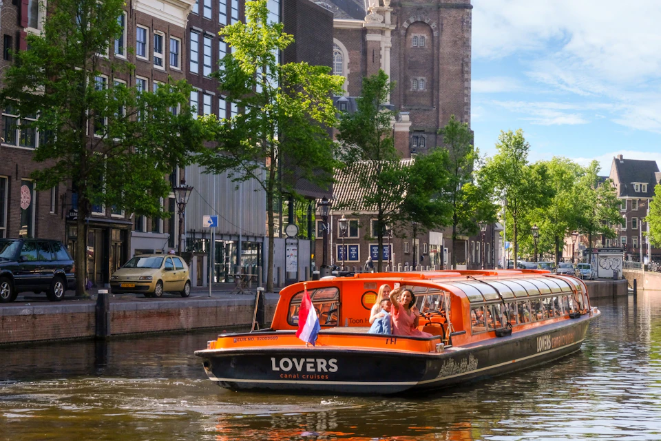 Lovers are cruising on a canal in a boat.