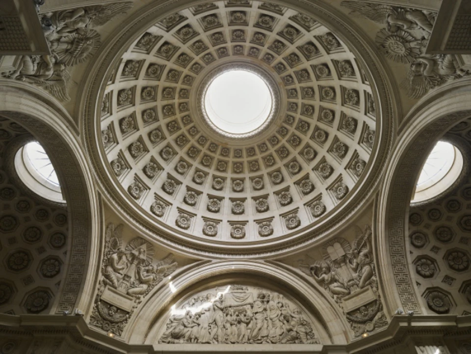 Ornate dome ceiling with a central oculus, intricate carvings, and detailed reliefs depicting various figures in classical style.