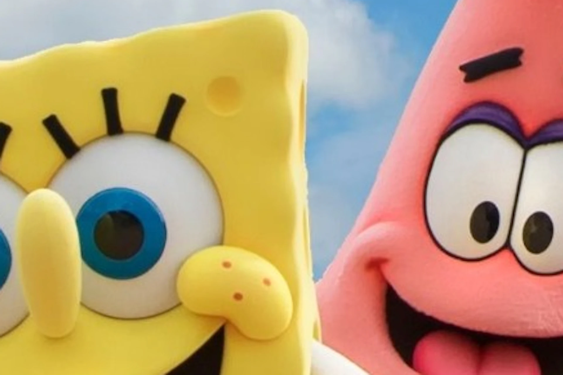 A group of cartoon character mascots, including a sponge, a starfish and a young explorer, posed at the entrance to an amusement park.