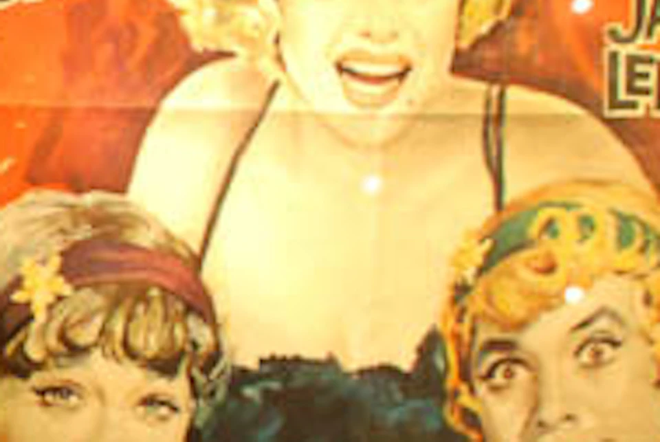 Framed black gloves displayed next to a vintage "Some Like It Hot" movie poster featuring Marilyn Monroe, Tony Curtis, and Jack Lemmon.