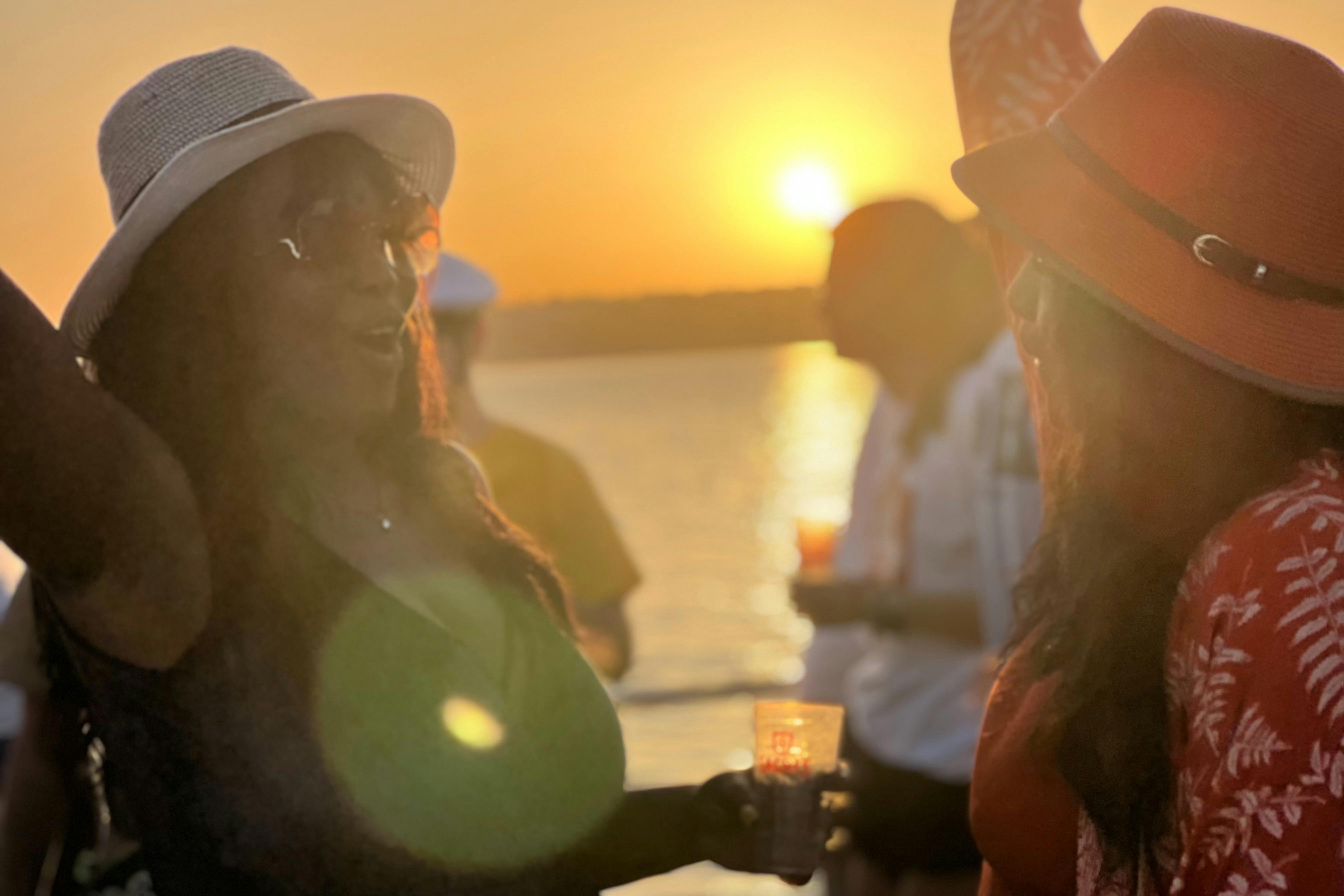 Two women enjoying sunset on a boat party in Lisbon