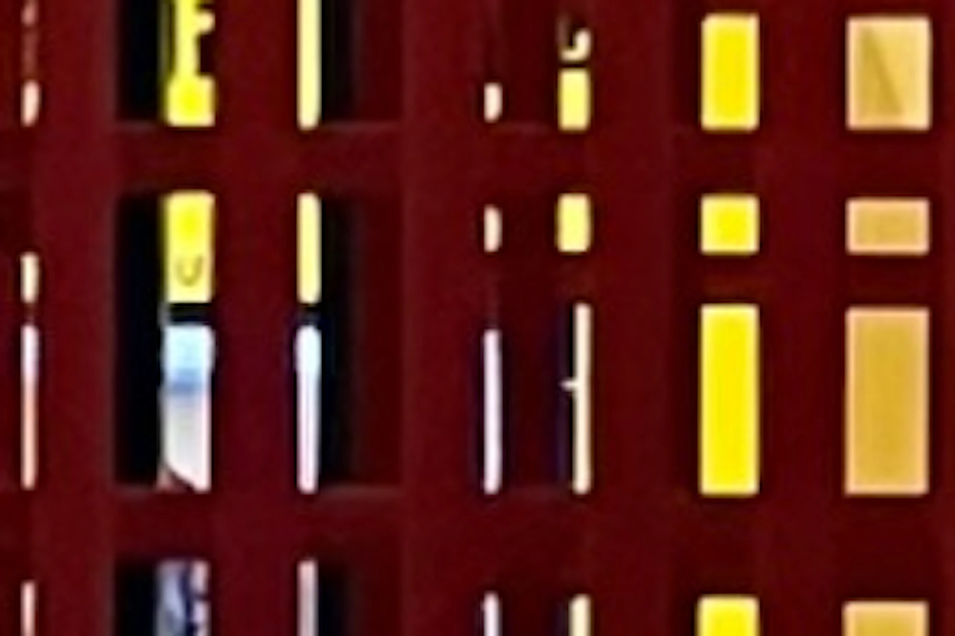 A person poses near a red and orange interactive exhibit with "GO" and "STOP" signs, wearing casual clothes and smiling.