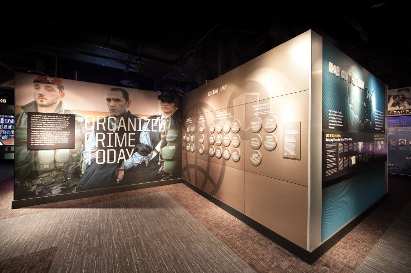 Exhibit with images of law enforcement officers, large text reading "Organized Crime Today," and informational panels on global law.
