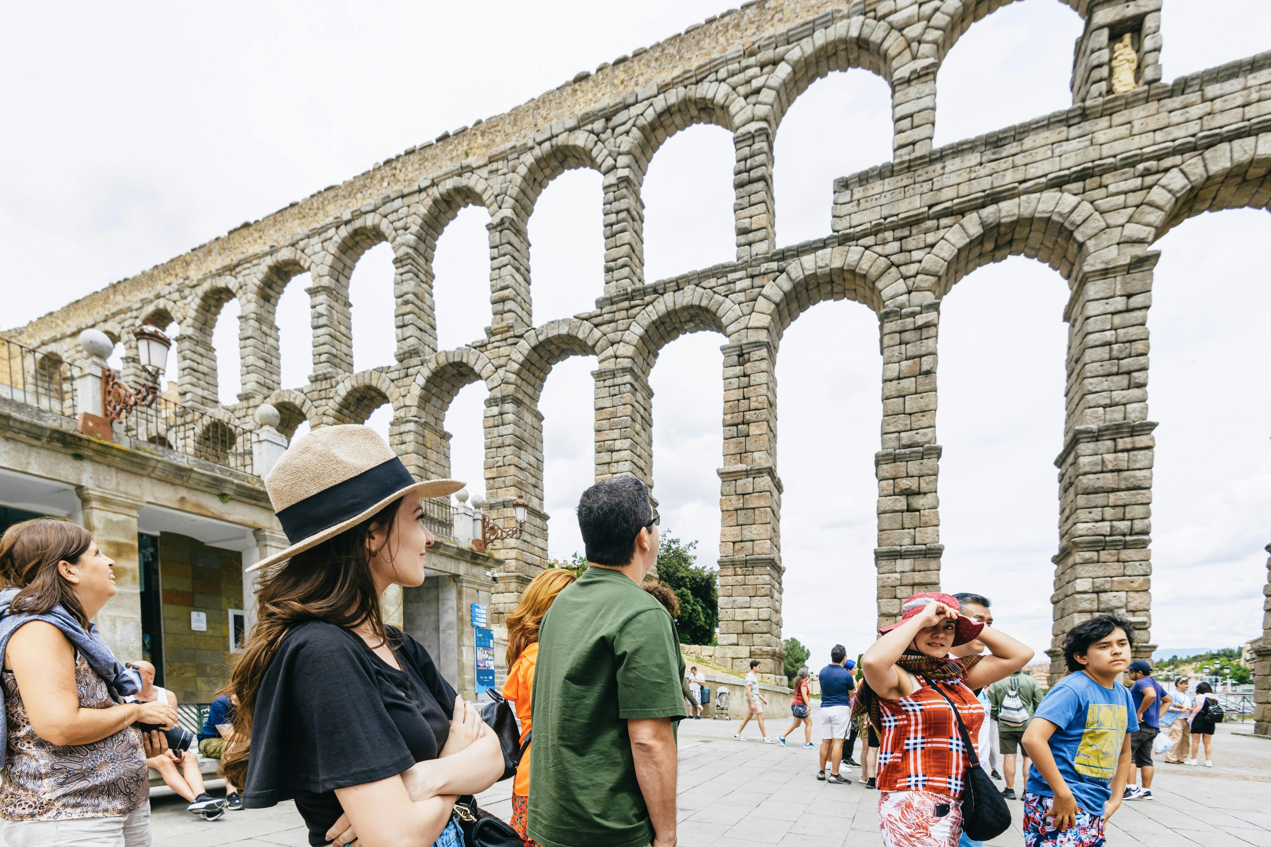 Tourist in front of the aqueduct in Segovia