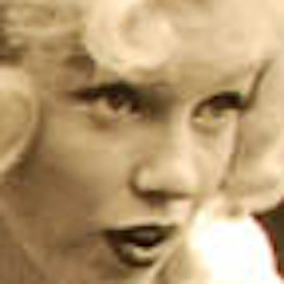 A vintage Rolleiflex camera is displayed next to a black-and-white photograph of a woman using the same camera model.