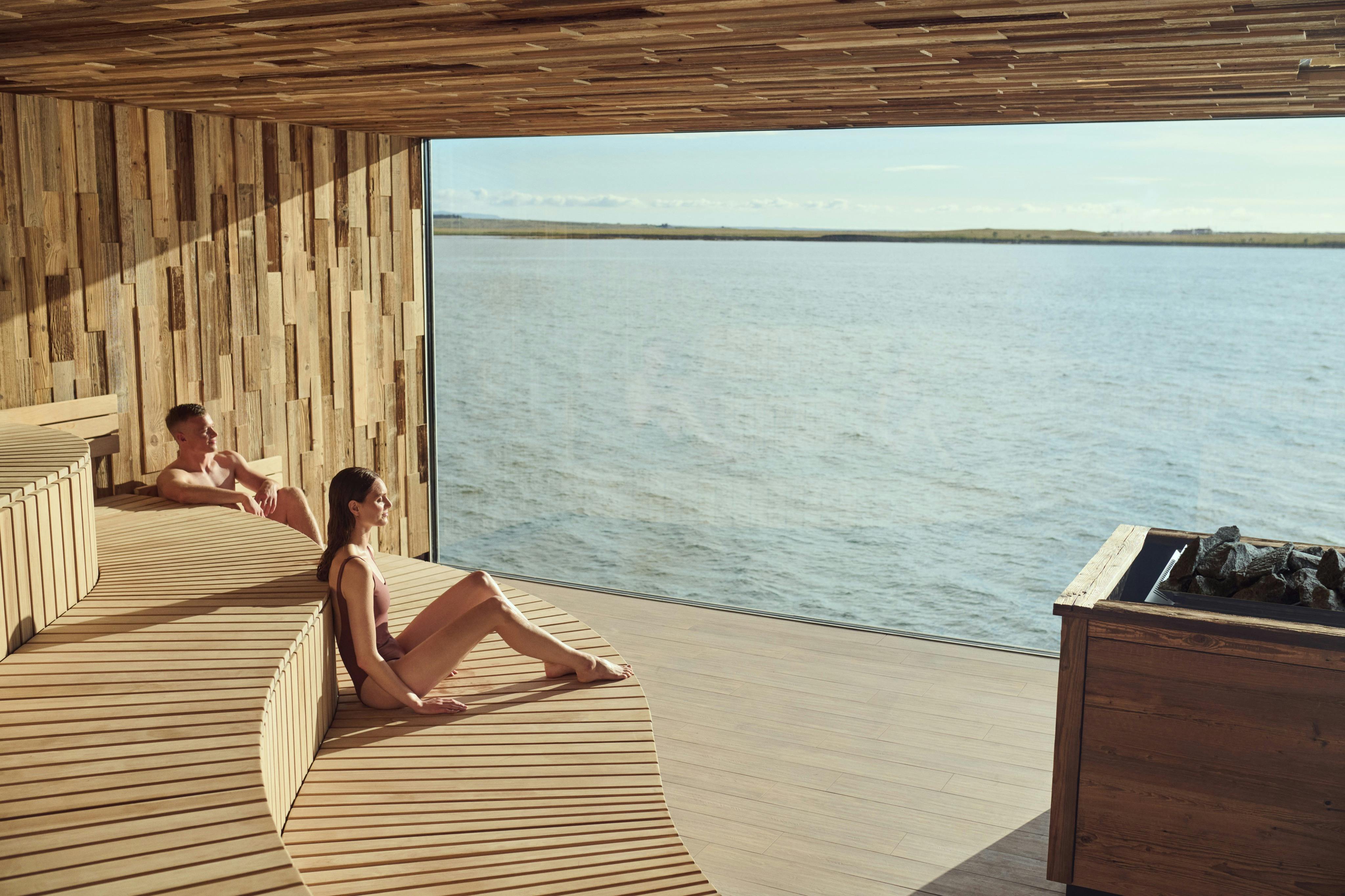 people in sauna with ocean view
