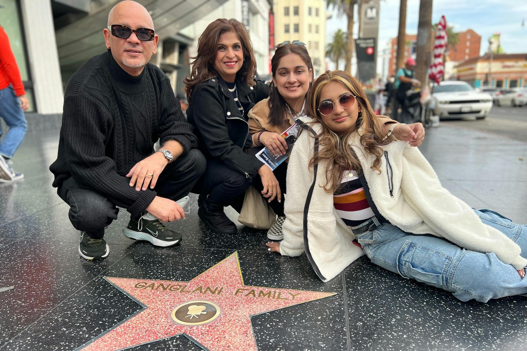 A  Hollywood Walk of Fame area  Tourist is happy with their own replica star personalized for a photo.#group