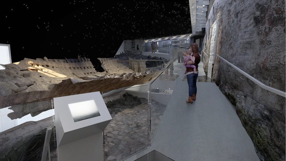 Woman holding a baby, looking at ancient shipwreck exhibit inside a modern museum under a starry sky ceiling.