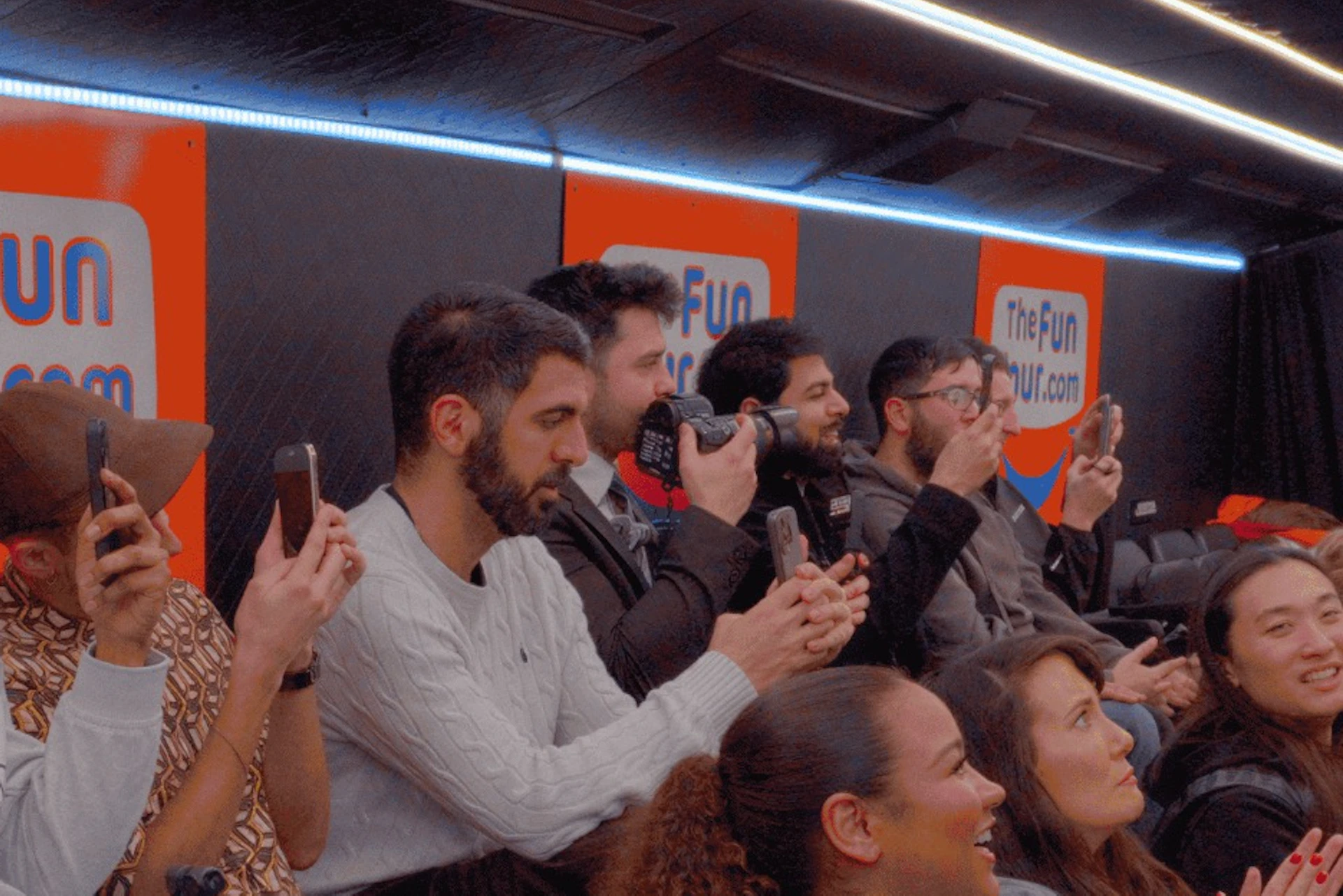 A group of people seated in an indoor venue with "The Fun Museum" signage visible on the walls.